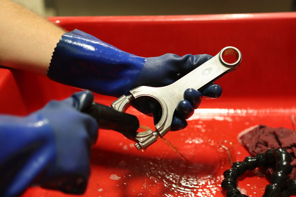 009-1024x683-1 connecting rod being cleaned in a parts washer